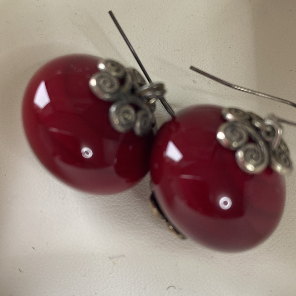 Made-by-hand red earrings. Intricate design.
